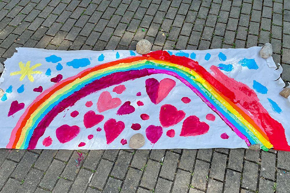 Image shows a rainbow, hearts, and a sun.